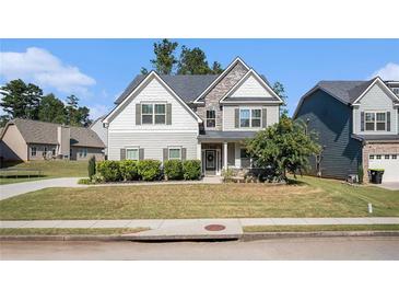 Two-story house with gray siding, stone accents, and a landscaped lawn at 2535 Grayton Loop, Villa Rica, GA 30180