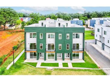 Modern townhome with green exterior, white accents, and individual balconies at 2029 Memorial Dr # 34, Atlanta, GA 30317