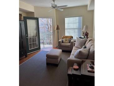 Bright living room with a ceiling fan, neutral color palette, and access to a balcony at 230 E Ponce De Leon Ave # 210, Decatur, GA 30030