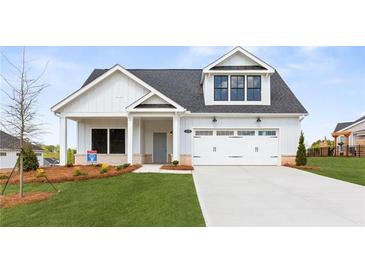 Charming new construction home with a two-car garage and well-manicured lawn at 5225 Ginger Rose Ct, Cumming, GA 30028