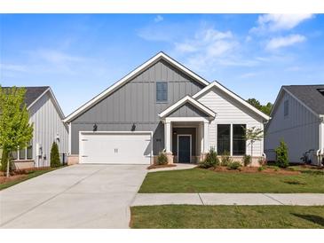 Charming single-Gathering home with a well-manicured lawn and a two-car garage in a suburban neighborhood at 248 Persimmon Dr, Holly Springs, GA 30115