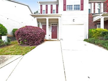 Charming two-story home featuring a well-maintained lawn and driveway leading to an attached garage at 4106 Dahlgreen Way, Decatur, GA 30032