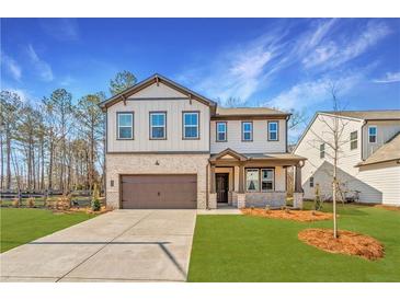 Charming two-story home with brick and siding, a well-manicured lawn, and a two-car garage at 111 Henley St, Canton, GA 30114