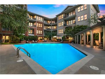 Inviting condo complex pool with lounge chairs and shaded seating at dusk at 3621 Vinings Slope Se # 3202, Atlanta, GA 30339