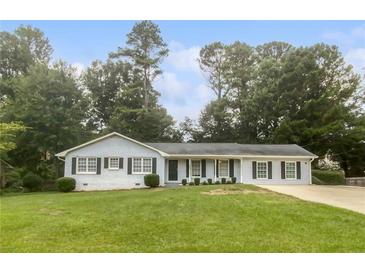 Charming single-story home with a well-manicured lawn and classic architectural details at 720 Smithstone Se Rd, Marietta, GA 30067