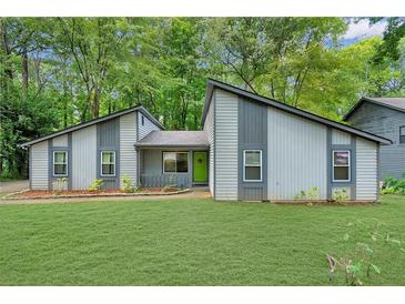 Charming single-story home featuring a well-manicured lawn and unique architectural design at 626 Dover St, Marietta, GA 30066