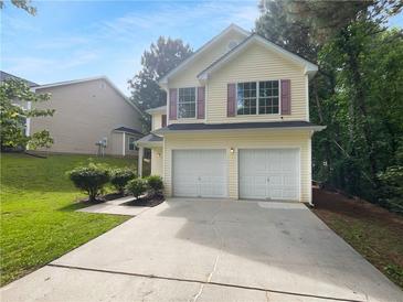 Charming two-story home featuring a two-car garage and manicured landscaping at 3227 Diamond Blf, Union City, GA 30291