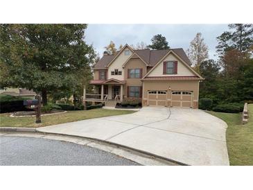 Two-story house with a large front yard, attached two-car garage, and covered porch at 89 Grand Oak Way, Dallas, GA 30157