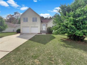 Charming two-story home with two-car garage and a well-manicured front lawn at 277 Players Cir, Fayetteville, GA 30215