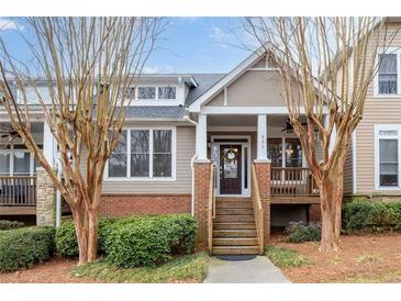Charming townhome with a welcoming front porch and well-maintained landscaping at 905 Freedom Ln, Roswell, GA 30075