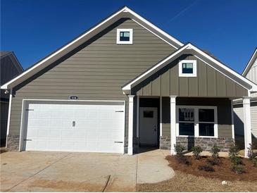 Charming single-story home with a two-car garage, complemented by stone accents and neat landscaping at 124 Sunflower Ne Cir, Cartersville, GA 30121