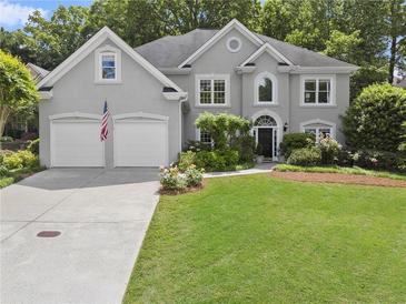 Charming two-story home with a well-manicured lawn and a two-car garage at 4055 Vinings Mill Se Trl, Smyrna, GA 30080
