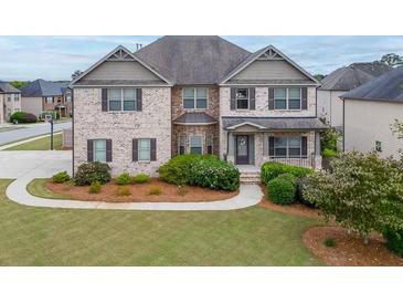 Two-story brick home with landscaped lawn and walkway at 3172 Trinity Grove Dr, Dacula, GA 30019