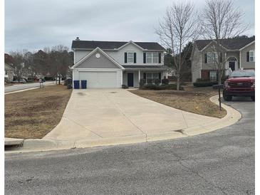 Two-story house with gray siding, a large driveway, and a well-maintained lawn at 101 Natalie Ct, Dallas, GA 30157