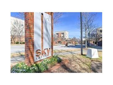 Sky Lofts signage is shown with a brick pillar and green plants at the base on a partly cloudy day at 898 Oak Sw St # 3108, Atlanta, GA 30310
