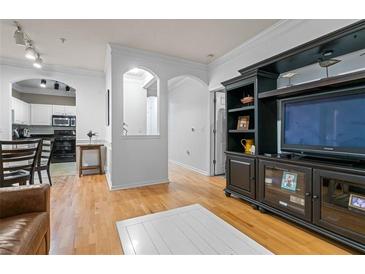 Inviting living room showcasing hardwood floors, white trim, and seamless flow into the adjacent kitchen area at 1850 Cotillion Dr # 3215, Atlanta, GA 30338