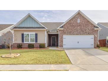 Charming one-story home featuring brick and siding exterior, manicured lawn and a two car garage at 4444 Kendrick Cir, Loganville, GA 30052