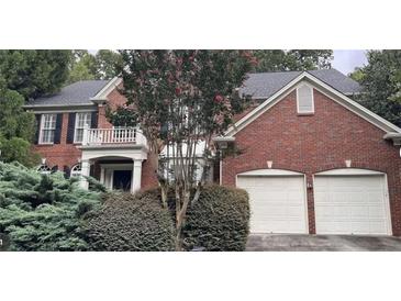 Brick two-story house with two-car garage and landscaping at 2082 Wrights Mill Ne Cir, Brookhaven, GA 30324
