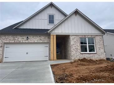 Two-story house with white siding, brick accents, and a two-car garage at 229 Mooney Rd, Woodstock, GA 30188