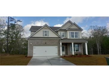 Charming two-story home with a brick facade, attached two-car garage, and well-maintained lawn at 6061 Spring Way, Stonecrest, GA 30038