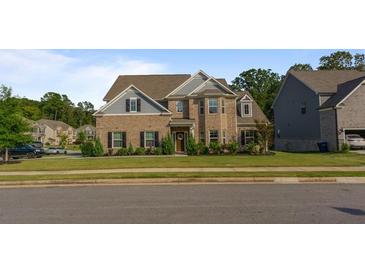 Brick two-story house with gray accents and a manicured lawn at 1995 Woodmont Dr, Douglasville, GA 30135