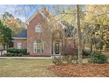 Brick home with landscaped yard and driveway at 1418 Brighton Pl, Loganville, GA 30052