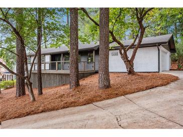 Charming home with a painted brick foundation, nice landscaping, and covered front porch at 2228 Old Dallas Sw Rd, Marietta, GA 30064