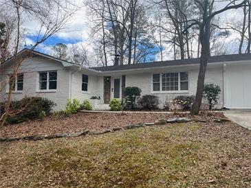 Charming single-story home boasts a freshly painted white exterior and a well-maintained front yard at 246 Plantation Sw Rd, Smyrna, GA 30082