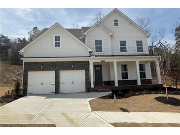 Charming two-story home features a two-car garage, covered porch, and beautiful stone accents at 337 Willow Cv, Canton, GA 30114
