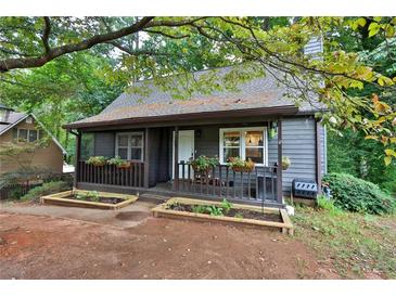 Charming one-story home featuring a cozy front porch with flower boxes and mature trees at 751 San Fernando Se Dr, Smyrna, GA 30080