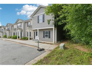 Traditional style gray townhouse with black shutters, covered porch and basketball hoop at 4001 Avalon Sw Rd, Atlanta, GA 30331