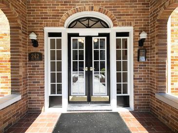 Inviting brick entrance with black double doors, side lights, and transom window above at 242 12Th Ne St # 8, Atlanta, GA 30309