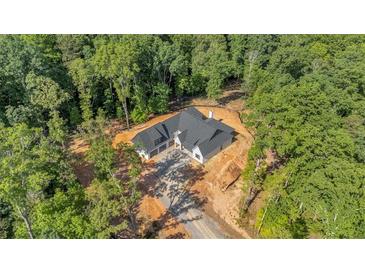 Stunning aerial view of the modern farmhouse-style home nestled in a lush, wooded lot at 107 Marks Way, Canton, GA 30115