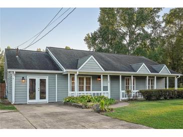 Charming single-story home boasts a covered front porch and a well-manicured lawn at 79 Russell Ln, Dallas, GA 30157