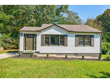 Charming single-story home with white siding, contrasting trim, and a well-manicured front lawn at 42 Guinn St, Marietta, GA 30060