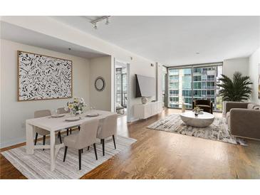 Open concept living and dining area with hardwood floors and city views at 270 17Th Nw St # 2410, Atlanta, GA 30363