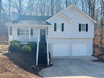 Gray house with white trim, two-car garage, and a staircase leading to the front porch at 194 Spring Leaf Dr, Dallas, GA 30157