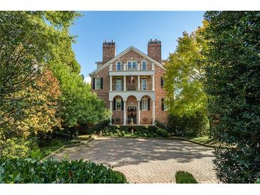 Stately brick home with manicured landscaping, columns, and a circular driveway at 3707 Peachtree Ne Rd # 1, Atlanta, GA 30319