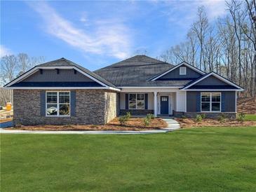 Two-story home with stone accents and a covered porch at 3393 Milan Ct, Douglasville, GA 30135