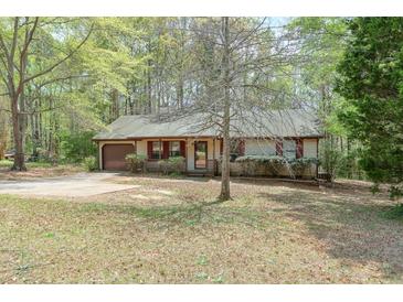 Charming single-story home with a driveway, neutral siding, and a well-maintained front yard at 798 Tommy Lee Cook Rd, Palmetto, GA 30268