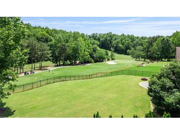Spacious, well-maintained backyard with lush grass, black fencing, and scenic golf course views at 8150 Albritton Downs, Cumming, GA 30041