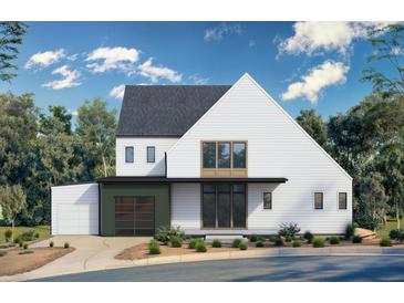 Modern two-story home with white siding, black trim, and a stylish garage door at 170 Cedarwood Ln, Roswell, GA 30075