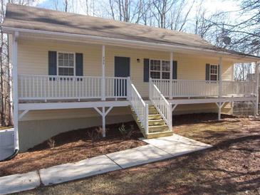 Inviting single-story home featuring a charming porch, well-maintained yard and sidewalk at 434 Spring Leaf Dr, Dallas, GA 30157