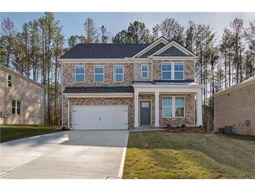 Charming two-story brick home with a two-car garage and well-maintained front yard at 125 Belvedere Rd, Mcdonough, GA 30253