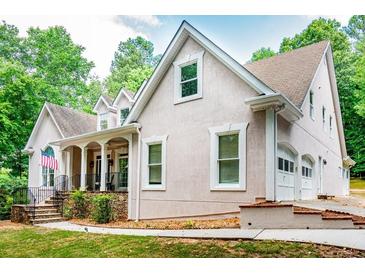 Charming home featuring a covered porch, stone accents, and attached two-car garage at 436 Westlake Dr, Marietta, GA 30064