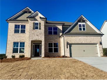 Two-story home with neutral brick, covered entry and two car garage at 409 West March Cir, Loganville, GA 30052