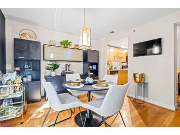 Bright dining room with a round table and four white chairs at 385 Ralph Mcgill Ne Blvd # E, Atlanta, GA 30312