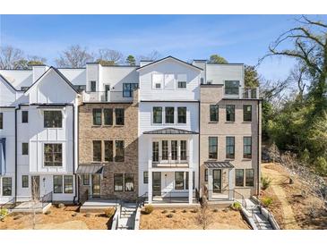 Three story townhome with white and brick exterior at 1788 Peach Blossom Ne Ln # 45, Atlanta, GA 30324