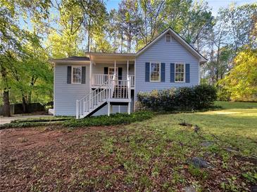 Charming single-Gathering home with a well-maintained lawn and inviting front porch at 5394 Muirwood Pl, Powder Springs, GA 30127