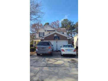 Two-story brick home with attached garage and basketball hoop at 4036 Angels Dr, Stockbridge, GA 30281